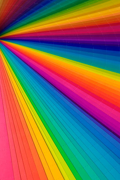Close-up of opened CMYK swatch book textured background.
