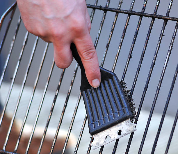 istock cleaning the grill with scrubber 157609806