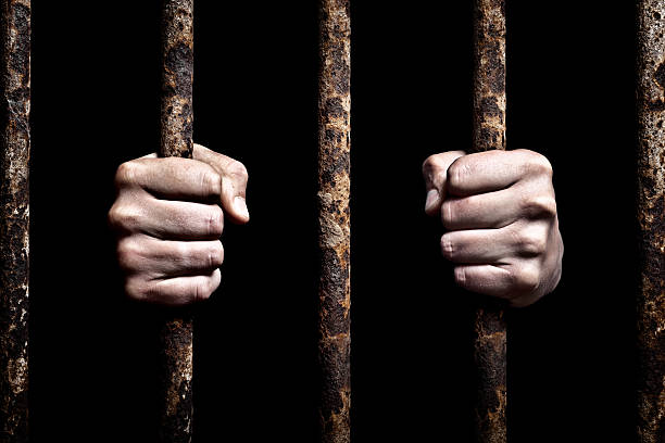 Prisoner Human hands on rusty cage bars. Canon 1Ds Mark III burglar bars stock pictures, royalty-free photos & images