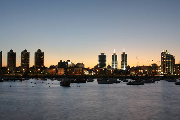 Montevideo cityscape at dusk from a marina stock photo