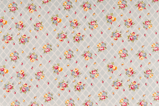 Antique grey floral fabric with trellis pattern..