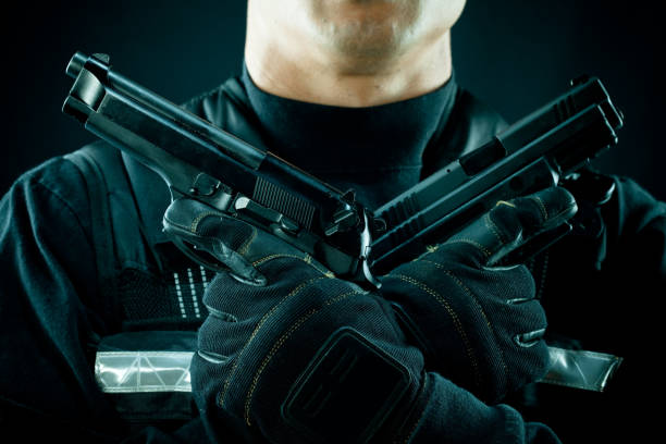istock swat officer holding cross guns 157610364