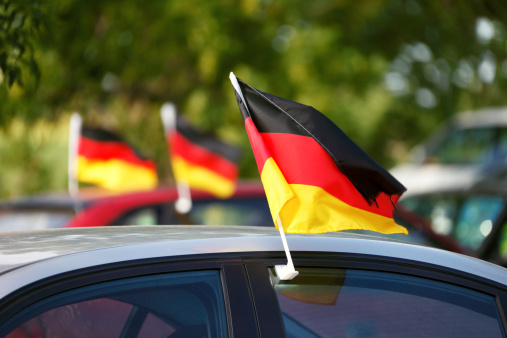 German World Cup flags hanging on cars.