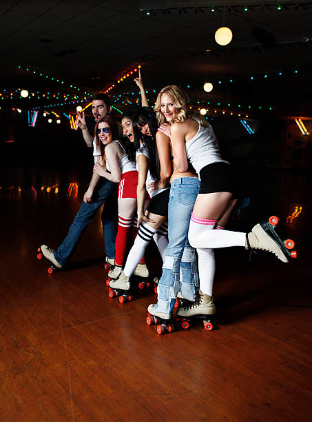 Retro 70's Roller Disco Conga Line Group of friends enjoying themselves at the roller disco. roller rink stock pictures, royalty-free photos & images