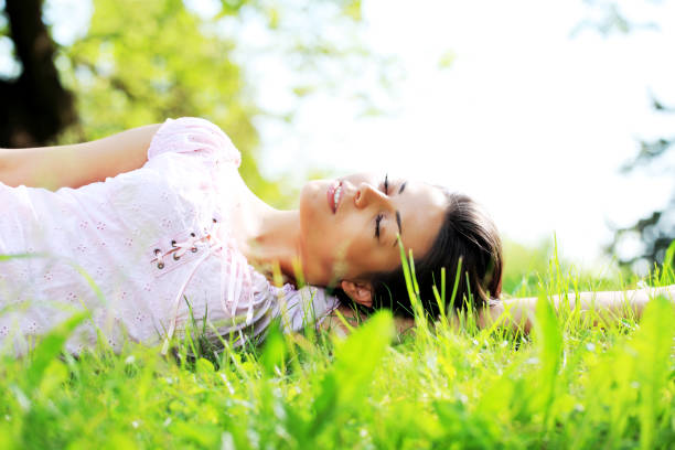 istock Young beautiful woman relaxing on the grass 157610823