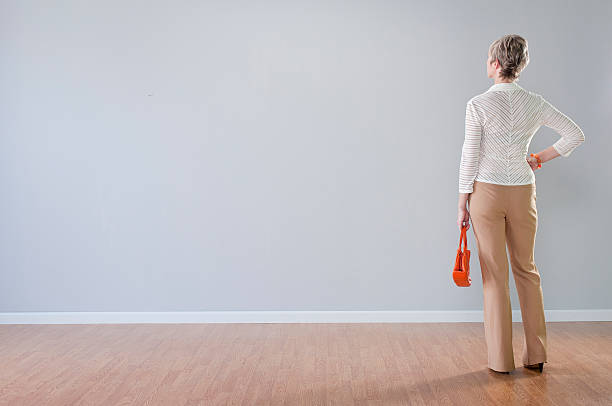 Stylish Woman Looking At Blank Wall