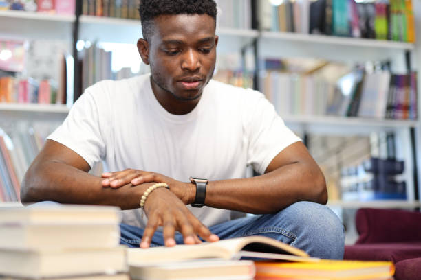 istock African student reads books in the library, preparing for exams. 1576111035