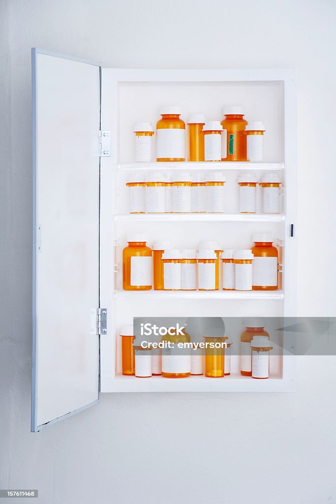 Medicine Cabinet A medicine cabinet filled with prescription bottles. Over 30 bottles, all with blank labels. Medicine Cabinet Stock Photo