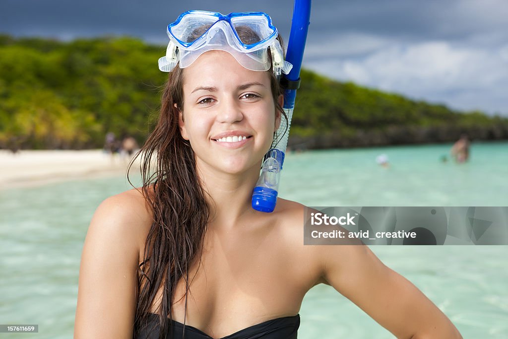 Cute Snorkeler Girl Portrait of a cute young female wearing a swim mask and snorkel at a beautiful tropical beach. Portrait Stock Photo