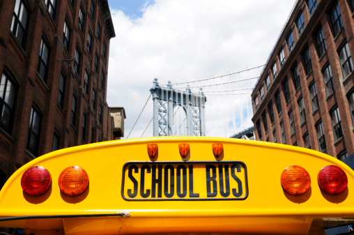 Top of a school bus,in the background Manhattan bridge,NYC.