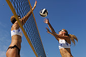 Beach volley action in mid-air