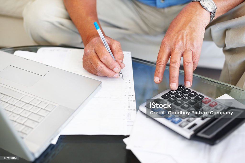 男性ご予算計算するには、ノートパソコンやカルキュレーター - 70代のロイヤリティフリーストックフォト