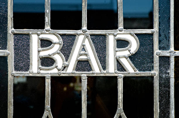 English pub window with an old fashioned bar sign.