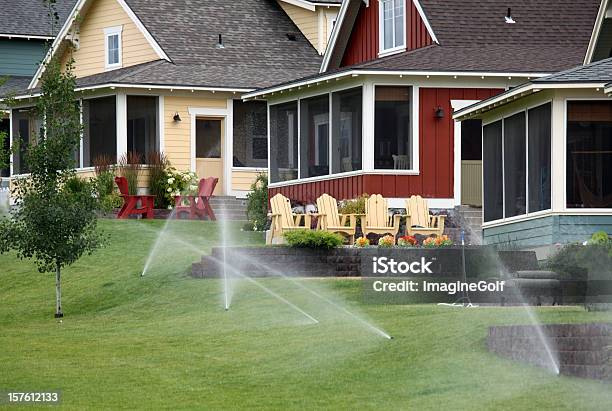 Sprinkler System In A Pretty Residential Community Stock Photo - Download Image Now - Irrigation Equipment, Yard - Grounds, Lawn
