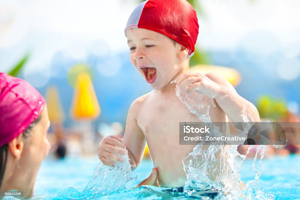 happy child mom swimming pool cap fun hug summer sea  Adult Stock Photo