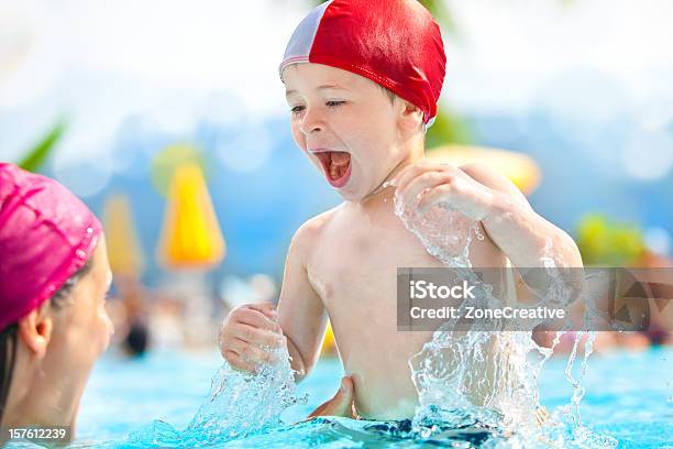 Happy Child Mom Swimming Pool Cap Fun Hug Summer Sea Stock Photo - Download Image Now