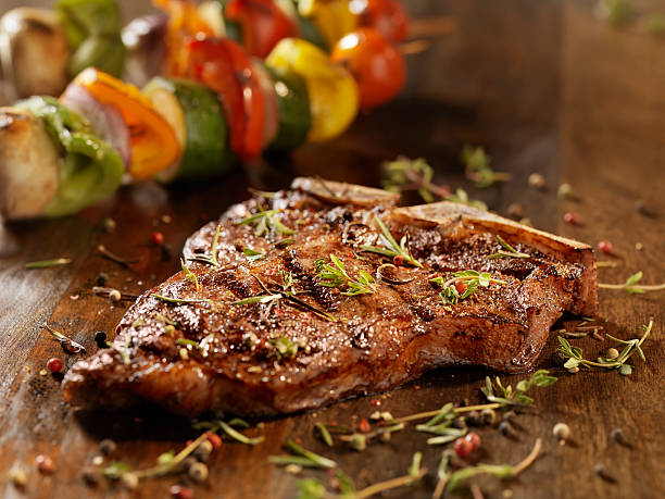 Porterhouse Steak with Fresh Herbs Porterhouse Steak with Fresh Herbs and Skewered Vegetables -Photographed on Hasselblad H3D2-39mb Camera porterhouse steak stock pictures, royalty-free photos & images