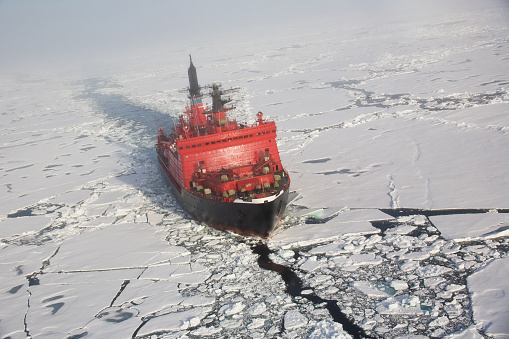 Russian nuclear ice breaker heading to the North pole through pack ice, aerial shot from helicopter