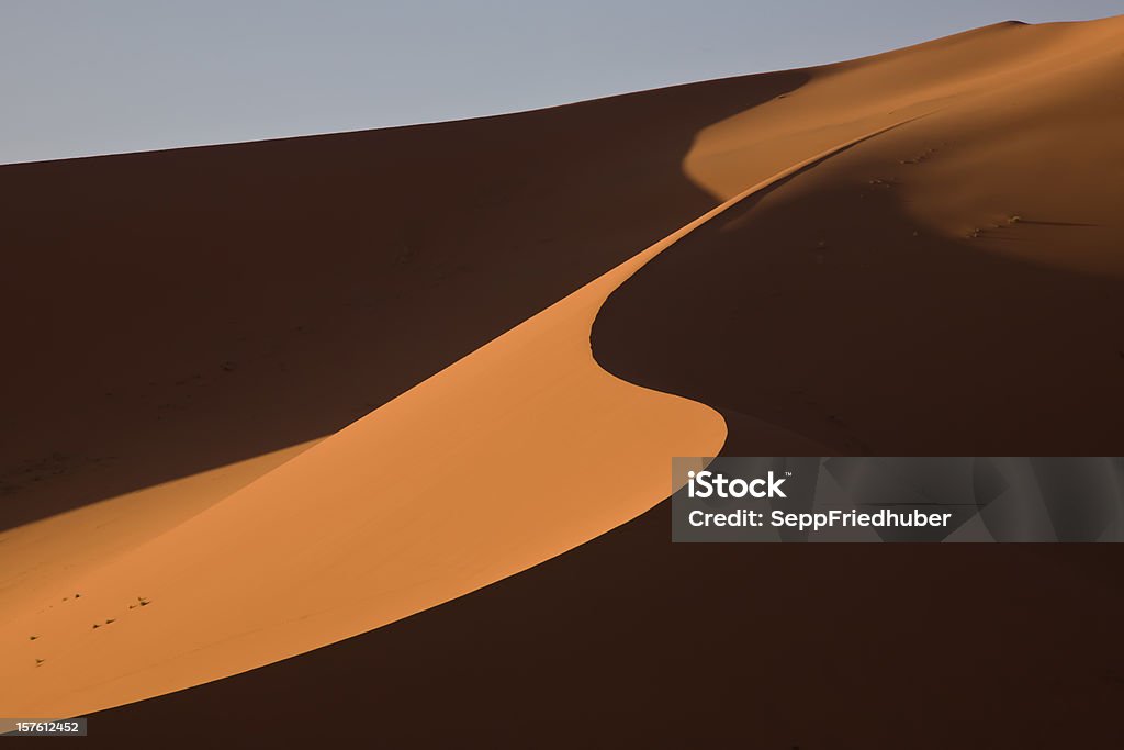 Sand dune between light and shadow in the Sahara Sand dune between light and shadow in the Sahara. Erg Muzugh, Fezzan, Libya,Copy space. Awbari Sand Sea Stock Photo