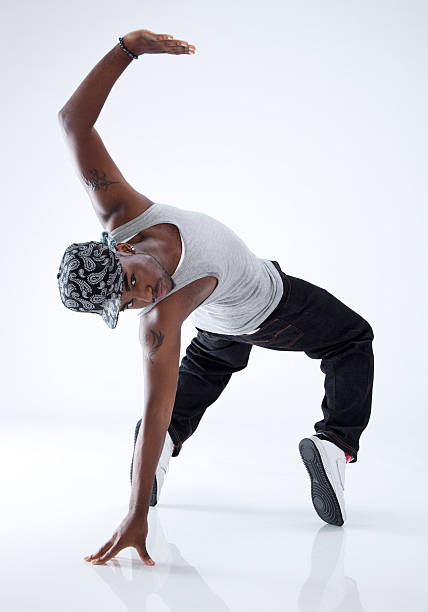 breakdancer on his toes breakdancer on his toes, doing a back bend on one hand, on white background breakdance stock pictures, royalty-free photos & images