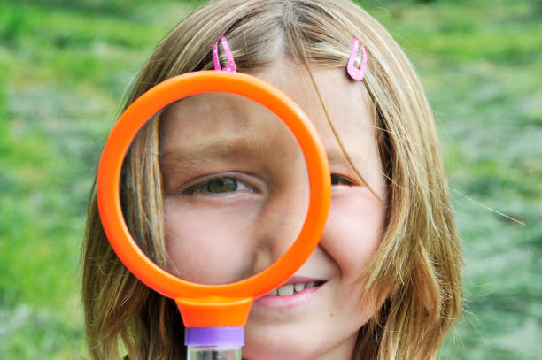 istock Girl explores with magnifying glass 157612531