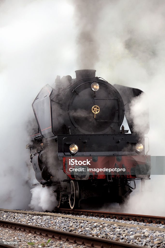 Old Fashion Steam Train close up shot of old Steam Locomotive in smoke. Steam Train Stock Photo