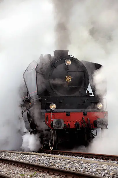 close up shot of old Steam Locomotive in smoke.