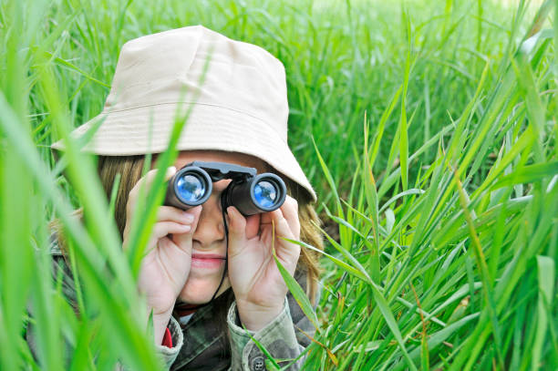 istock Young girl explores nature with binoculars 157612619