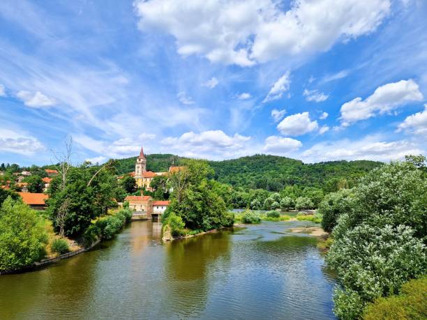A view of Sazava Monastery and Sazava river under blue sky and white clouds in Sazava town in Central Bohemia, Czech Republic.
