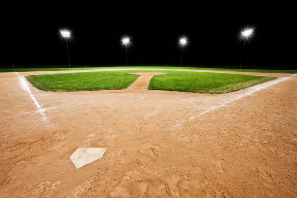 istock An empty baseball diamond with stadium lights in background 157612745