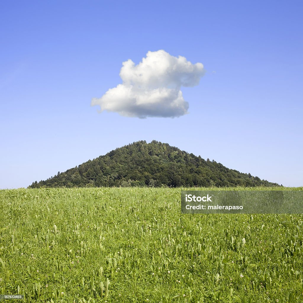 Small cloud above the mountain top Small cloud above the mountain top.  Agricultural Field Stock Photo