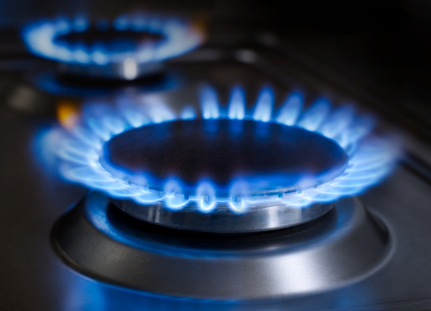 Blue flames from gas stove burner. High res photo of blue flames from a kitchen gas range.