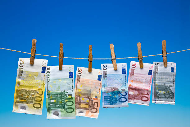 Wet Euro banknotes hanging on a clothesline Euro banknotes washing five euro banknote photos stock pictures, royalty-free photos & images