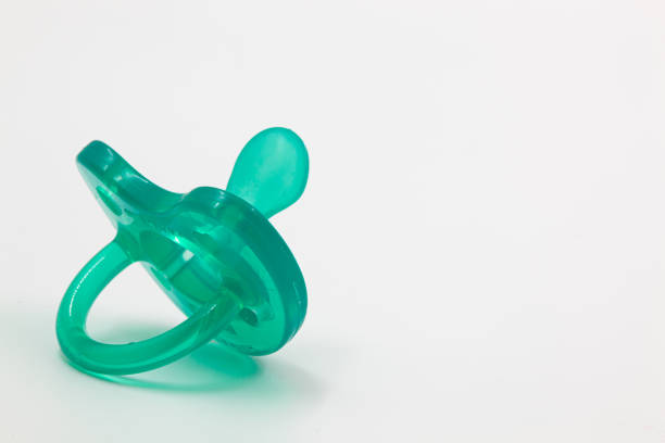 istock Turquoise pacifier for a newborn on a white insulated background. 1576130751