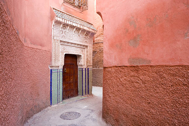Marrakesh, The Red City Beautiful Moroccan door decorated by carved stucco on a hidden alley in the old Medina of Marrakesh, Morocco. marrakesh photos stock pictures, royalty-free photos & images
