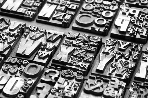 background of random vintage grunge letterpress metal type printing blocks
