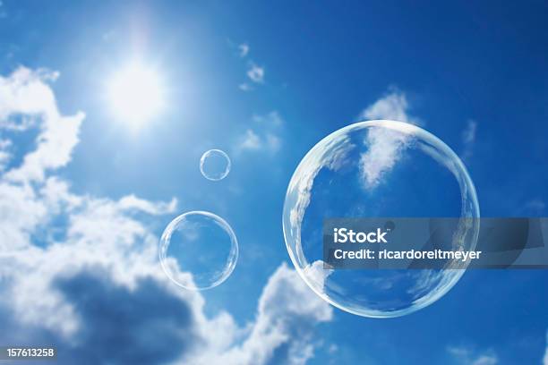 Floating Soap Bubbles Against Clear Sunlit Blue Sky And Clouds Stock Photo - Download Image Now