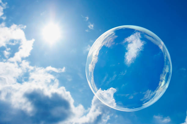 istock Floating Soap Bubble Against Clear Sunlit Blue Sky and Clouds 157613261