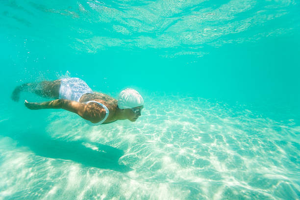 istock woman diving underwater 157613447