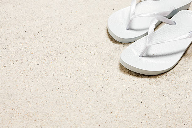 Rope sandals on the beach, top view