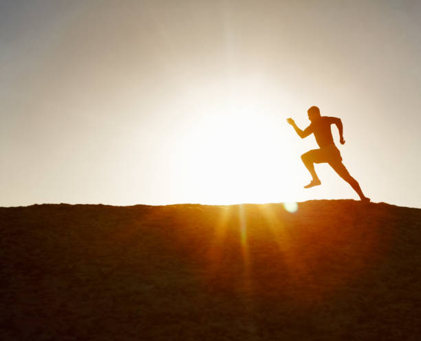 istock Silhouette image of an active runner against clear sky 157613912