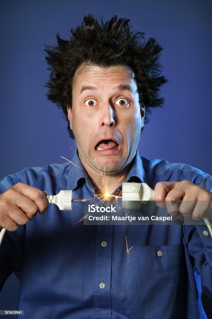 Shocked Man on Blue - Sparks Series of a man with electrified hair and shocked expression. Electricity Stock Photo