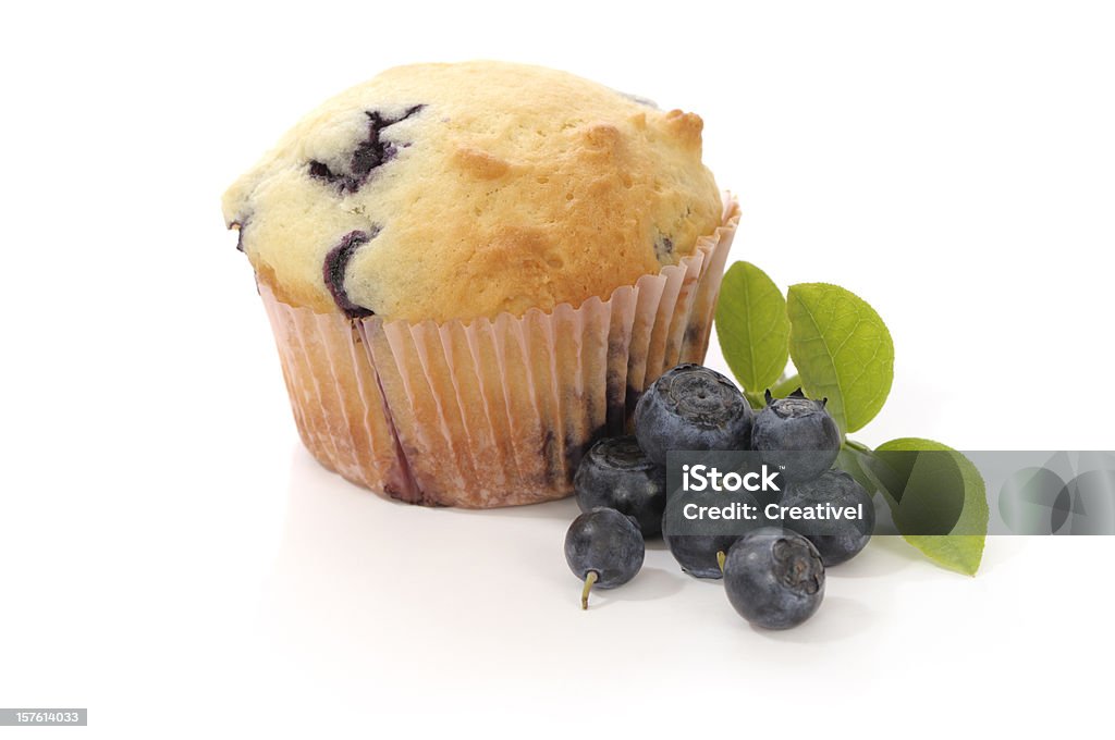 Blueberry Muffin and fresh blueberries, isolated on white  Blueberry Muffin Stock Photo