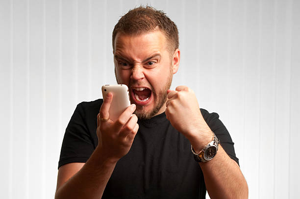 young male screams at phone  exhilaration stock pictures, royalty-free photos & images