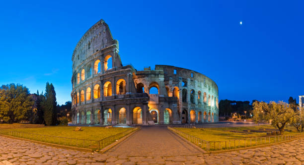 istock Rome Coliseum ancient Roman amphitheatre illuminated piazza panorama Italy 157614278