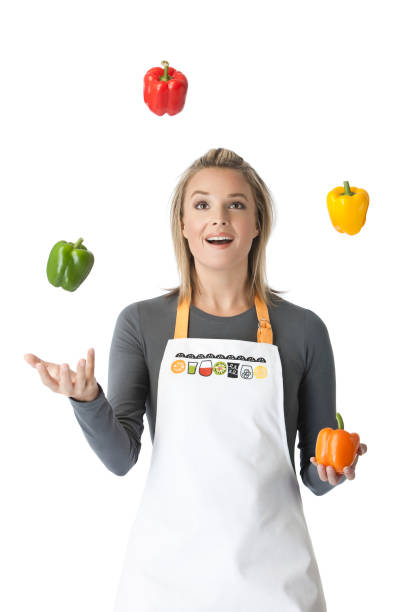 Beautiful woman Juggling With Four Peppers stock photo