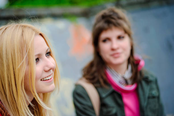 Two young university students in casual wear smiling