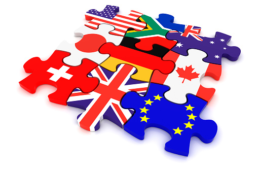 Jigsaw puzzle pieces textured with United Kingdom and Hong Kong flags on white. Horizontal composition with copy space. Clipping path is included.