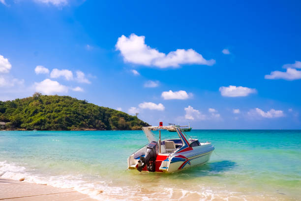 Speedboat and wave slider leaving trail on water, with other boats and sea as background with copy space. Aerial seascape