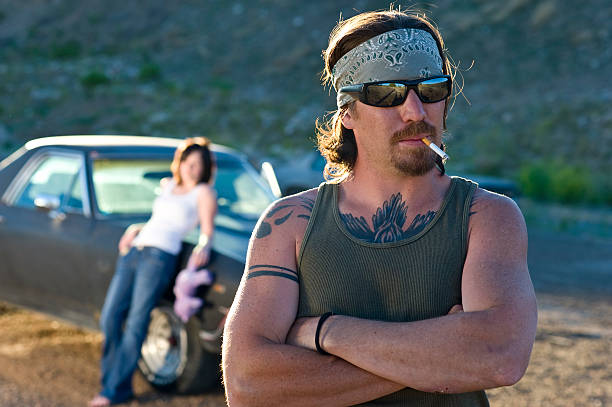 istock Rustic man smokes in front of girlfriend and el camino 157614514